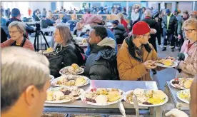  ??  ?? Those who help others were most likely to thrive. Volunteers fill plates with food in November during the Homeless Alliance Thanksgivi­ng dinner at the WestTown day shelter in Oklahoma City. [BRYAN TERRY/ THE OKLAHOMAN ARCHIVE]