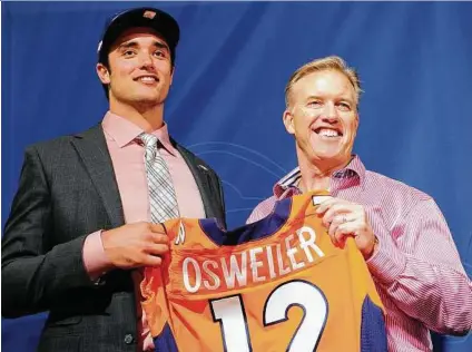  ?? Hyoung Chang / Denver Post ?? Brock Osweiler, left, and Broncos GM John Elway were all smiles after the 2012 draft. They’re reunited now after a rancorous parting last year.