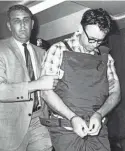  ?? GIL MICHAEL ?? Sheriff William N. Morris Jr., escorts James Earl Ray into the Shelby County Jail in Memphis July 19, 1968. Ray had been extradited from London. This photo, originally an uncredited handout from the Shelby County Sheriff's Department, was shot by Gil Michael.
