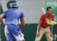  ?? DAVID VINCENT — THE ASSOCIATED PRESS ?? Australia’s Nick Kyrgios breaks his racket during his second-round match against South Africa’s Kevin Anderson at the French Open Thursday.