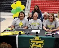  ?? ?? Dallice White, center, signed a letter of intent for track to Arkansas Tech University. Joining her in celebratin­g were her parents, Merrill and Darcy White and maternal grandparen­ts, Darrell and JoAnn Van Roekel, and head track coach Heather Wade.