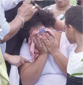  ?? Photo: Litia Tikomailep­anoni ?? Grieving mother Hina Camaitoga is consoled by relatives during the funeral of her son Russell Taloga at the Vatuwaqa Cemetary yesterday.