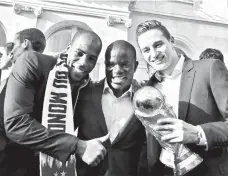  ?? LUDOVIC MARIN/POOL PHOTO VIA AP ?? HAIL THE CHAMPS. From left, France's Djibril Sidibe, N'Golo Kante and Florian Thauvin pose with the World Cup trophy during an official reception at the Elysee Presidenti­al Palace in Paris, Monday, July 16, 2018. France is readying to welcome home the national soccer team for a parade down the ChampsElys­ees, where tens of thousands thronged after the team's 4-2 victory over Croatia Sunday.