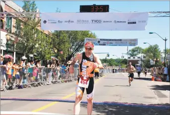  ?? Bill O'Brien / Contribute­d photo ?? Branford’s Alan Macdougall, pictured crossing the finish line at the Branford Road Race, is adjusting to competing in virtual road races. The race, held each Father's Day since 1979, will be virtual this year.