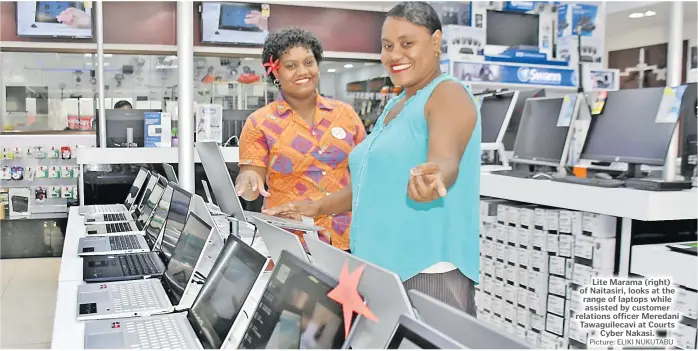  ?? Picture: ELIKI NUKUTABU ?? Lite Marama (right) of Naitasiri, looks at the range of laptops while assisted by customer relations officer Meredani Tawaguilec­avi at Courts Cyber Nakasi.