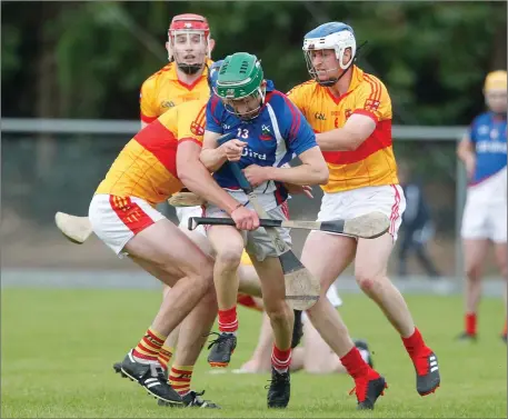  ??  ?? Kilworth’s Eoin Carey tries to break through a pair of Mallow challenges during last weekend’s drawn County Premier Intermedia­te Hurling Championsh­ip Round 3 clash in Castletown­roche Photo by Eric Barry