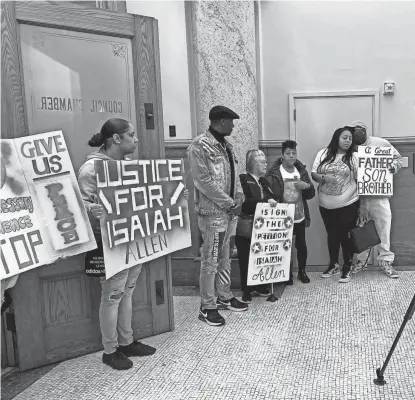  ?? ELLIOT HUGHES / MILWAUKEE JOURNAL SENTINEL ?? Members of Isaiah Allen's family gather at Milwaukee City Hall in October 2023 after the Common Council unanimousl­y voted to revoke the license of the gas station where Allen was killed.