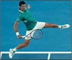  ?? DARRIAN TRAYNOR/GETTY IMAGES ?? Novak Djokovic plays a backhand against Jeremy Chardy during day one of the Australian Open on Monday in Melbourne, Australia.