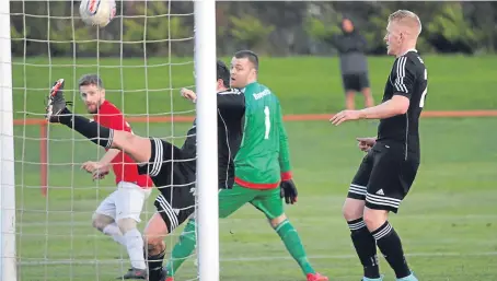  ?? Picture: Peter Rundo. ?? A St Andrews defender gets back to clear off the line and deny Tayport a late equaliser.