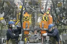  ?? Giulia Marchi/The New York Times ?? Workers produce cars at the Ford plant in Hangzhou, China.