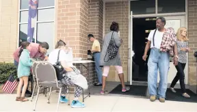  ?? JOSHUA BOUCHER News Herald/AP ?? Voters enter the supervisor of elections office mega-voting site in Panama City on Nov. 6, 2018. As Panama City recovered from Hurricane Michael, voters in Bay County were allowed to vote at any of the mega-voting sites across the county.