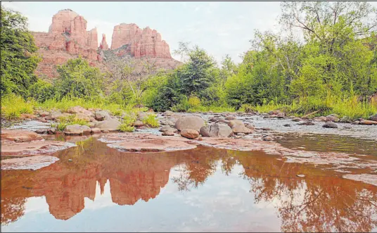  ?? Scott Troyanos The Associated Press ?? The parking lot for the trailhead at Cathedral Rock in Sedona, Ariz., could close at peak times for a new shuttle service.