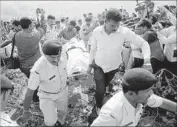  ?? Sanjeev Gupta European Pressphoto Agency ?? POLICE remove the bodies of prisoners near Bhopal, India. The fugitives appeared to have been unarmed.