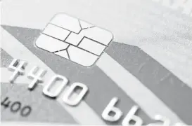  ?? Matt Rourke / Associated Press ?? This chip-based credit card is an example of the kind that will be going to millions of Americans by autumn, replacing the old magnetic strip cards.