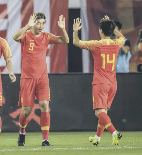  ??  ?? 0 Chinese players celebrate a goal during the World Cup 2022 qualifier football match between China and Guam in Guangzhou last month
