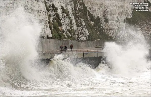  ?? ?? Seafront soaking ...waves crash over Saltdean promenade