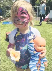  ??  ?? Lucy enjoying her sausage at Te Puna Playcentre open day. PHOTO: Supplied.