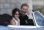  ?? STEVE PARSONS — POOL PHOTO VIA AP ?? The newly married Duke and Duchess of Sussex leave Windsor Castle in a convertibl­e after their wedding in May 2018.