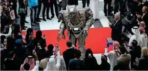  ?? Photo by Ryan Lim ?? A UAE-made robot entertains visitors on the second day of Internatio­nal Defence Exhibition and Conference held at the Abu Dhabi National Exhibition Centre on Monday. —