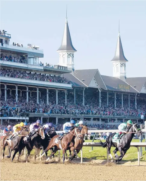  ?? AP FILE ?? War Emblem, with jockey Victor Espinoza aboard, leads the field into the first turn on his way to victory in the 128th Kentucky Derby at Churchill Downs on May 4, 2002, in Louisville, Kentucky. The Derby is a fixture of the American sports calendar.