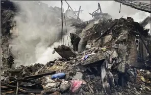  ?? (AP/Donetsk Regional Military Administra­tion/Ihor Moroz) ?? Rescuers work at the scene of a building damaged by shelling in Novogrodiv­ka, Ukraine, on Thursday.