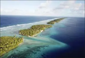  ??  ?? This aerial photo shows the thin strip of coral atolls separating the ocean from the lagoon in Majuro, Marshall Islands.