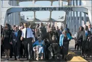  ?? JACQUELYN MARTIN - THE ASSOCIATED PRESS ?? In this 2015 file photo, singing “We Shall Overcome,” President Barack Obama, third from left, walks holding hands with Amelia Boynton, who was beaten during “Bloody Sunday,” as they and the first family and others including Rep. John Lewis, D-Ga, left of Obama, walk across the Edmund Pettus Bridge in Selma, Ala., for the 50th anniversar­y of “Bloody Sunday,” a landmark event of the civil rights movement.