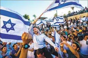  ?? ISRAELI POLITICIAN Marcus Yam Los Angeles Times ?? Bezalel Smotrich is carried by a crowd of far-right supporters in Jerusalem in 2021. Hard-line policies against Palestinia­ns undermine long-term stability.