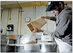  ?? The New York Times/GEORGE ETHEREDGE ?? A worker pours barley that will be used to make flour at Rise Products, a startup in New York where the goal is to cut food waste.
