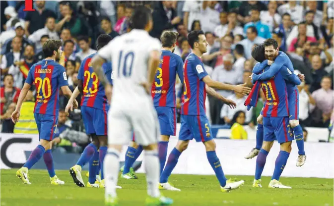  ?? AP ?? MADRID: Barcelona’s Lionel Messi (right) celebrates with teammates after scoring the winning goal during a Spanish La Liga match between Real Madrid and Barcelona, dubbed ‘El Clasico’, at the Santiago Bernabeu stadium yesterday. Barcelona won 3-2.—