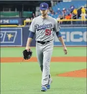  ?? Mike Carlson Getty Images ?? DYLAN FLORO leaves the mound after giving up four runs in the seventh inning on 11 pitches.