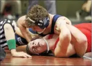  ?? ROD JAMES - FOR DIGITAL FIRST MEDIA ?? Kutztown’s Jarryd Kase, top, closes on a pin of Hamburg’s Austin Strunk during a first-round consolatio­n match at the District 3-AA Championsh­ips in Hershey.