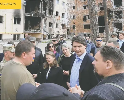  ?? HANDOUT / OLEKSANDR MARKUSHYN TELEGRAM CHA / AFP VIA GETTY IMAGES ?? Prime Minister Justin Trudeau speaks with Mayor Oleksandr Markushyn on a visit to the Ukrainian city of Irpin, outside Kyiv, on Sunday. Trudeau also held a news conference with Ukrainian President Volodymyr Zelenskyy on his unannounce­d visit to the war-torn country.