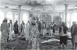  ?? GETTY-AFP ?? Taliban fighters investigat­e inside a Shiite mosque after a suicide bomb attack Friday in Kunduz, Afghanista­n, that left at least 46 people dead.