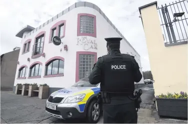  ??  ?? Police outside The Royal Oak in Carrickfer­gus after a doorman suffered serious head injuries