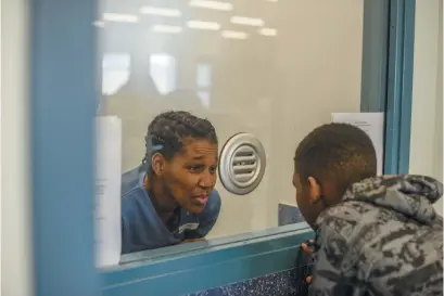  ??  ?? A mother talking with her son through a window at the Florida Women’s Reception Center, a prison in Ocala, Florida, April 2016; photograph by Isadora Kosofsky from her series ‘Still My Mother, Still My Father,’ which documents parent–child visits in...