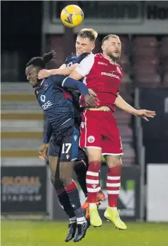  ??  ?? Heads up Ross Mcgeachie challenges two Ross County attackers