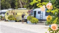  ?? DANIEL A. ANDERSON ?? A guest hangs lights on his van at Waypoint Ventura, which has one of the largest number of vintage trailers in the state.