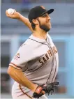  ?? Photos by Harry How / Getty Images ?? Madison Bumgarner was workmanlik­e — seven hits and two runs in six innings.