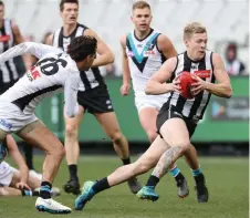  ?? Picture: MICHAEL KLEIN ?? Collingwoo­d's Jordan De Goey evades the Port Adelaide defence at the MCG yesterday