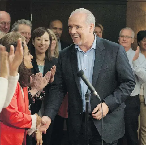  ?? JASON PAYNE/PNG ?? B.C. NDP Leader John Horgan is surrounded by incumbent and newly-elected NDP MLA’s during a caucus meet in Vancouver on Thursday. Electoral reform is becoming a hot topic between the parties.