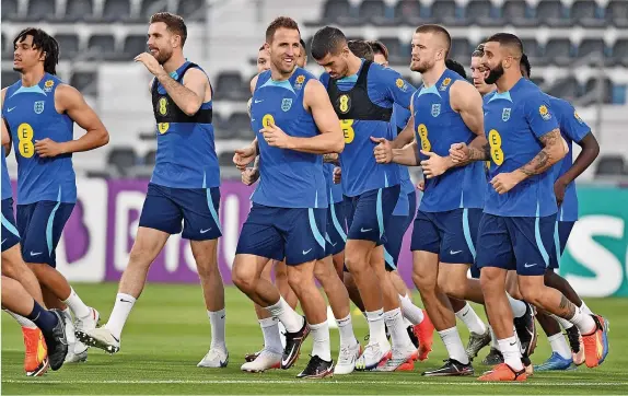  ?? Andy Stenning ?? > The players enjoy a gentle jog at their Sports Club training base in Al Wakrah, Qatar. England play their first game against Iran on Monday