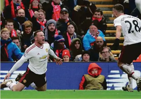  ?? Reuters ?? Pitch perfect Manchester United’s Wayne Rooney celebrates scoring against Liverpool with teammate Morgan Schneiderl­in during their Premier League match at Anfield on Sunday.