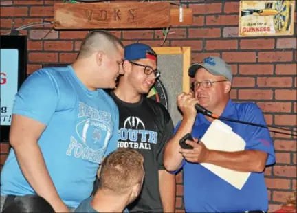  ?? PAUL DICICCO — THE NEWS-HERALD ?? Nathan Tekavec, left, and Joe Lang are interviewe­d after they won The News-Herald Senior Bowl wing eating contest June 4 at Hooley House.