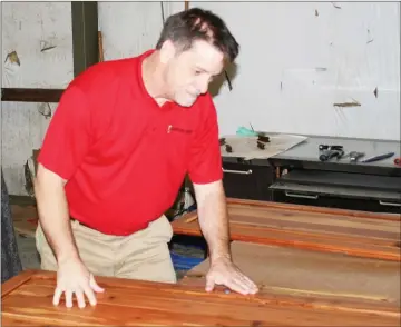  ?? Doug Walker / Rome News-Tribune ?? ABOVE: Furniture Medic Operations Manager Terry Trace works on a cedar shelf in his shop at 14 Commerce Court.