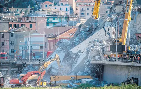  ?? AFP ?? Rescuers work amid the rubble and wreckage of the Morandi motorway bridge in Genoa yesterday, three days after a section collapsed. Italy’s populist government intensifie­d its attacks on the viaduct operator amid rising anger over the tragedy and the structural problems that have dogged the decades-old bridge, which buckled without warning on Tuesday.