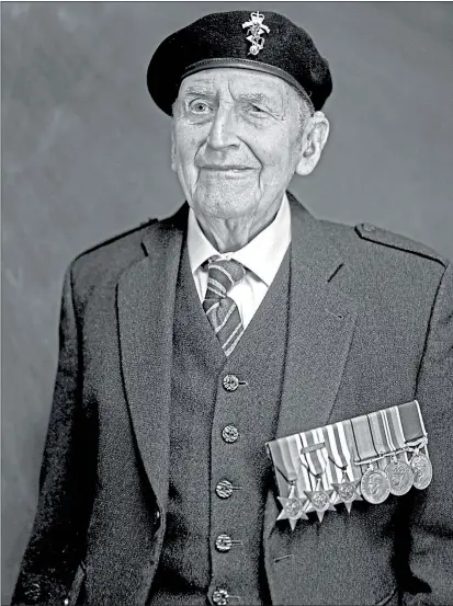  ?? Picture ?? John McOwan proudly displays his medals and salutes fallen comrades
Wattie Cheung