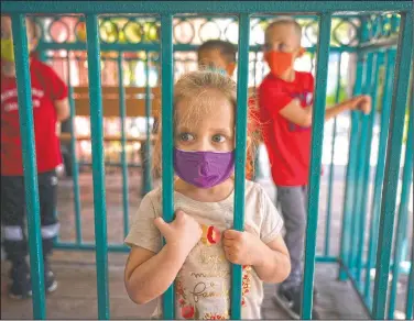  ?? (AP/Jae C. Hong) ?? Zayla LeClair, 3, waits to ride a train at Adventure City on opening day in Anaheim, Calif.