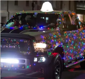  ?? Tim Godbee ?? A Dodge Ram truck is outfitted with Christmas lights during the Calhoun Christmas parade in December 2018.