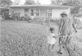  ?? Melissa Phillip / Houston Chronicle ?? Wendlyn Hill, shown with great granddaugh­ter Harmony Wolfe, has applied for the roof repair program. “When it rains, I know water’s coming here,” she said.